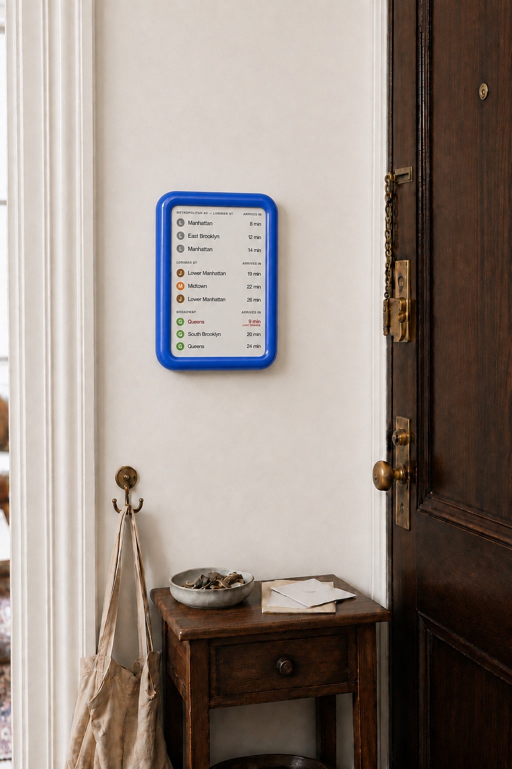 OnMyWay display in blue, mounted in the entryway of an older building